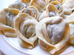 A plate of formed dumplings ready to cook