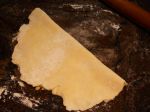 Folding the pie crust in half for transferring it to the plate